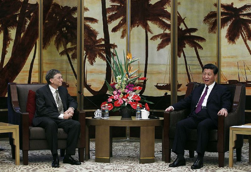 China's President Xi Jinping, right, speaks with Microsoft founder Bill Gates during their meeting at the annual Boao Forum in Boao, in southern China's Hainan province, Monday, April 8, 2013. (AP Photo/Tyrone Siu, Pool)