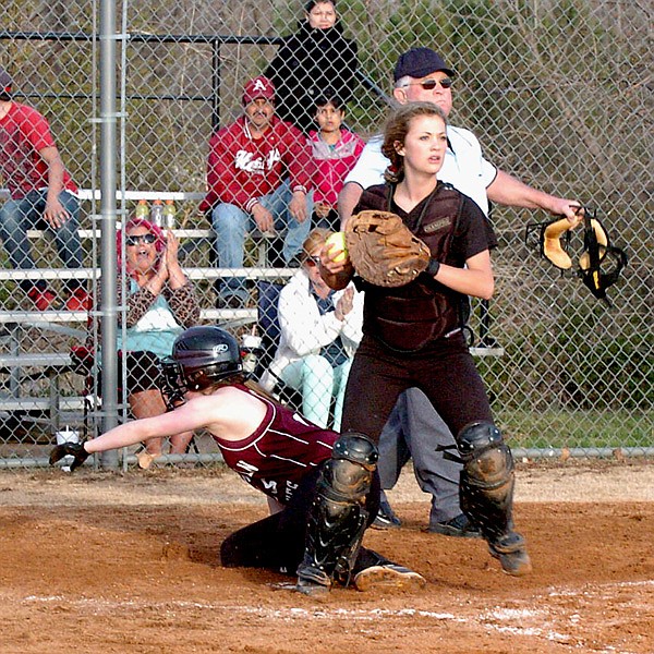After a play at home plate, Gentry catcher Shannea Smartt looks to second, ready to throw, in play against Lincoln on Friday. 