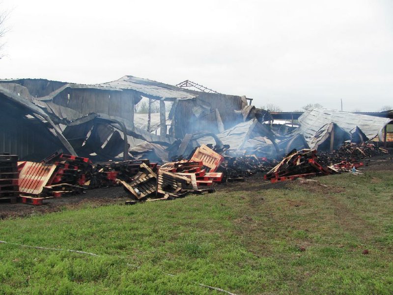 The assembly area of the Medlock Forest Products plant in Charleston still smoldered Wednesday morning after fire destroyed the building and six truckloads of pallets waiting to be shipped. Firefighters were able to save the mill area, office and the office manager’s home on the site. 