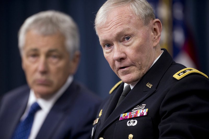 Defense Secretary Chuck Hagel, left, sits next to Joint Chiefs Chairman Gen. Martin Dempsey as he speaks during a news conference at the Pentagon on Wednesday, April 10, 2013, about the fiscal year 2014 defense budget. 