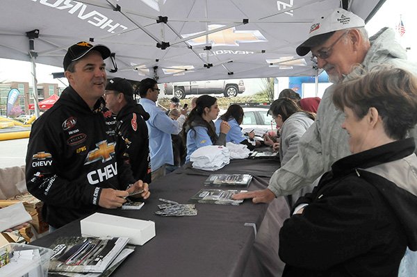 FLW pro Jay Yelas of Oregon, left, talks with Jim and Wanda Anderson of Fayetteville on Saturday April 13 2013 at the Walmart FLW Tour expo at the John Q. Hammons Center.