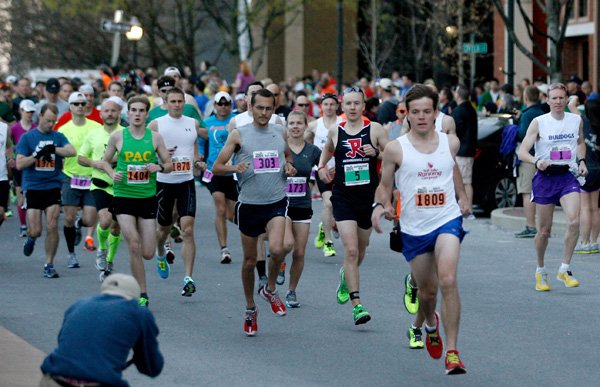 Runners leave the starting line to begin the 37th annual Hogeye Marathon on Sunday in downtown Fayetteville. 