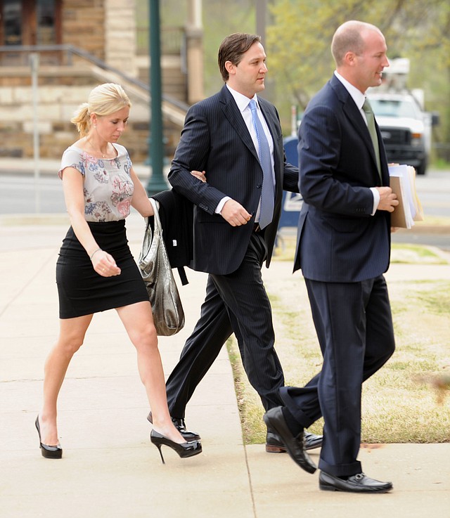 Former developer Brandon Barber, center, is escorted into the John Paul Hammerschmidt Federal Building by associate Kristen Foodim, left, Monday, April 15, 2013, in Fayetteville. 