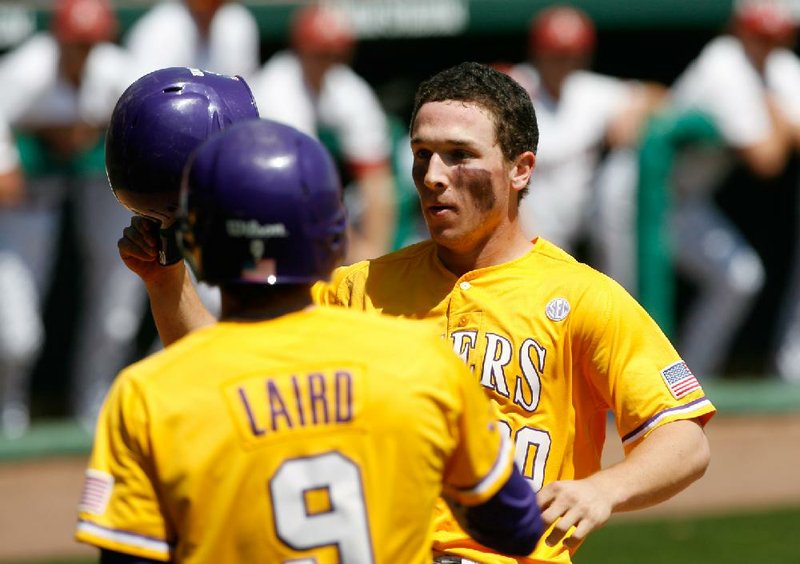 NWA Media/JASON IVESTER
Louisiana State's Alex Bregman is congratulated by teammates after hitting a two-run homerun in the top of the third inning against Arkansas on Sunday, April 14, 2013, at Baum Stadium in Fayetteville.