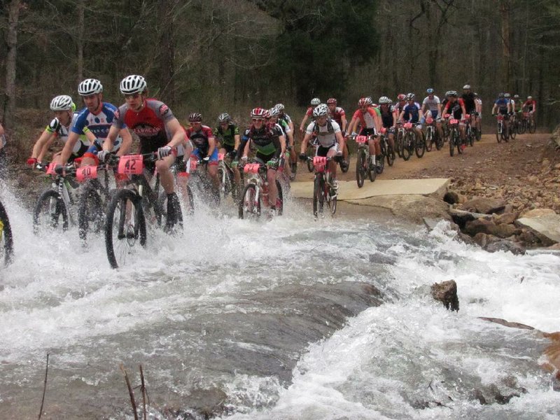 Kevin Conerly (No. 42) pedals with pack leaders across Big Brushy Creek during the Ouachita Challenge race April 7 in the Ouachita National Forest in Montgomery County. Conerly won the 60-mile mountain-biking event in 4:40:52. 