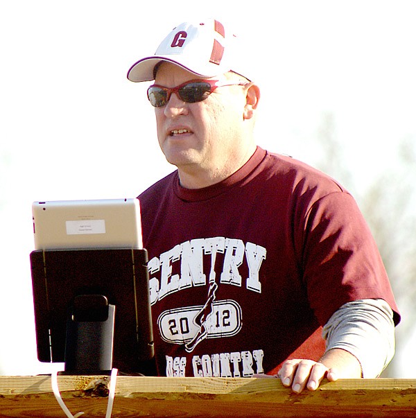 With an iPad mounted on a platform, Gentry coach Daniel Ramsey video records the finish of running events during a track meet last week.