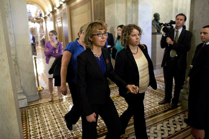 Former Democratic Rep. Gabrielle Giffords of Arizona, who was wounded in a shooting in 2011, leaves the Capitol on Wednesday after the Senate defeated a bill she supported to expand background checks for gun buyers. 