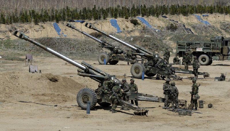 South Korean soldiers prepare 155mm howitzers during a military drill Thursday in the border city of Paju. 