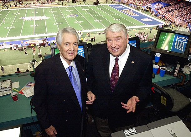 In this Feb. 3, 2002 file photo, Fox broadcasters Pat Summerall, left, and John Madden stand in the FOX broadcast booth at the Louisiana Superdome before Super Bowl XXXVI in New Orleans. Madden, the burly former coach who has been one of pro football's most popular broadcast analysts for three decades, is calling it quits. Madden worked for the past three seasons on NBC's Sunday night NFL game. His last telecast was the Super Bowl between Arizona and Pittsburgh. (AP Photo/Ric Feld, File)