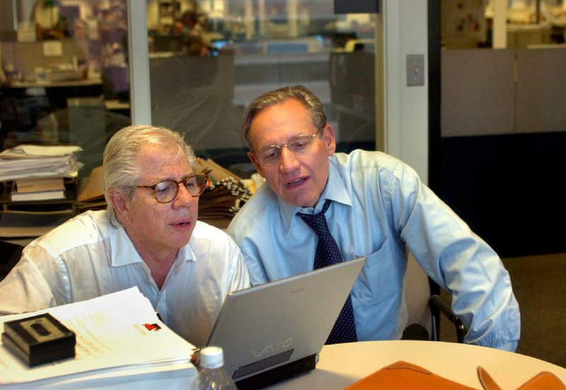 Watergate reporters Carl Bernstein, left, and Bob Woodward in Woodward's office at the Washington Post, Tuesday, May 31, 2005 the day Deep Throat was outed by Vanity Fair. (AP Photo/Katherine Frey, Washington Post)