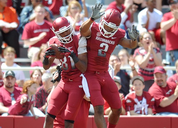 Arkansas players Demetrius Wilson (left) and Julian horton celebrate after scoring a touchdown during Saturday's Red White Scrimmage at Razorback Stadium in Fayetteville.