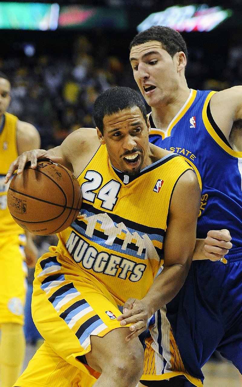 Denver Nuggets guard Andre Miller (left) drives to the basket against Golden State Warriors guard Klay Thompson on Saturday at the Pepsi Center in Denver. 