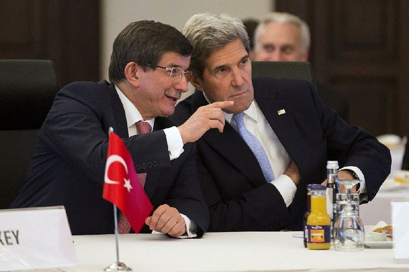 U.S. Secretary of State John Kerry, right, talks with Turkish Foreign Minister Ahmet Davutoglu during a "Friends of Syria" group meeting hosted by Davutoglu at the Adile Sultan Palace on  Saturday, April 20, 2013, in Istanbul, Turkey. Kerry is expected to announce a significant expansion of non-lethal aid to the Syrian opposition. (AP Photo/Evan Vucci, Pool)