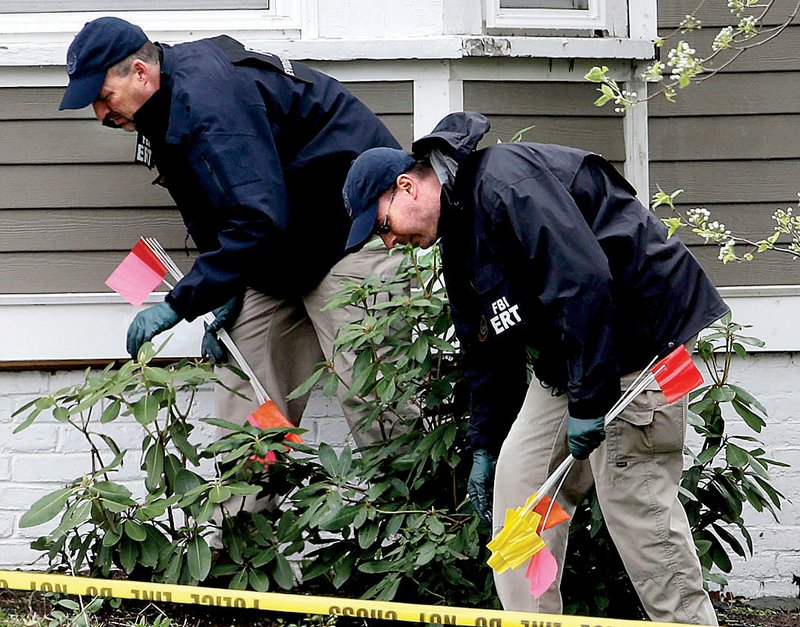 Investigators in Watertown, Mass., work Saturday near the location where Dzhokhar Tsarnaev, a suspect in the Boston Marathon bombings, was arrested Friday.