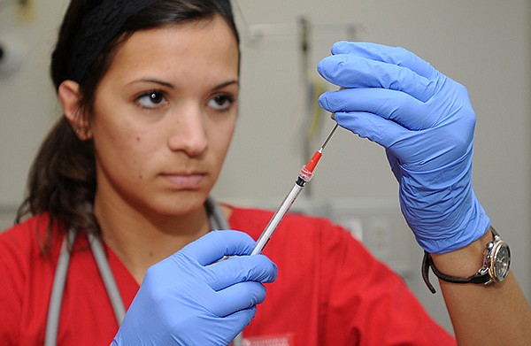 Lauren Delph, second-semester nursing student, fills a syringe with medication during a demonstration Wednesday, April 17, 2013, at the Epley Center for Health Professionals on campus at the University of Arkansas in Fayetteville. The University accepts 100 students per semester into the two-year nursing program.