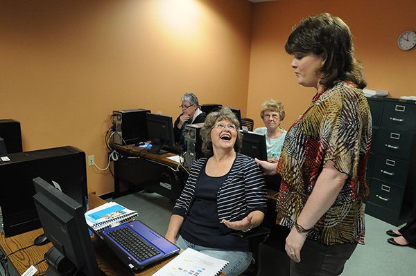 Patty Hall, community education director for Northwest Technical Institute, right, helps Billie Vandervort, of Winslow, during a computer class Tuesday, April 16, 2013 for seniors at the Jones Center in Springdale. The class covers a few basics of computer use including personalized setting, secure web searches and anti-virus software.