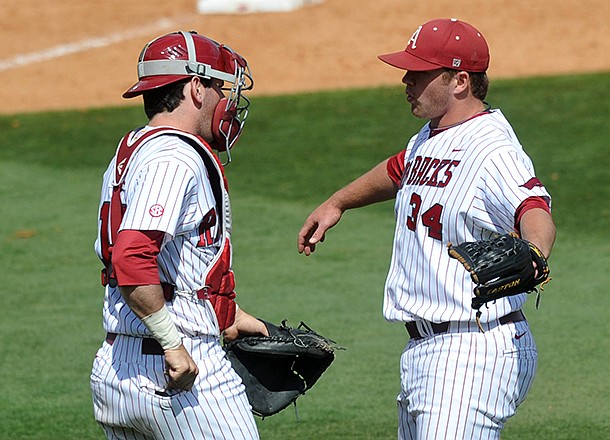 Arkansas catcher Jake Wise congratulates pitcher Colby Suggs after he picked up the save in Arkansas' 2-1 win over Texas A&M Sunday afternoon at Baum Stadium in Fayetteville.