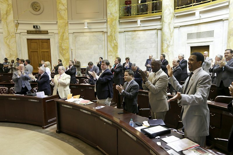 Members of the Arkansas House of Representatives applaud as the current legislative session is recessed at the Arkansas state Capitol in Little Rock, Ark., Tuesday, April 23, 2013.