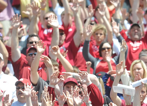 University of Arkansas Razorback fans call the hogs as they prepare for the start of Saturday's Red White Scrimmage at Razorback Stadium in Fayetteville.