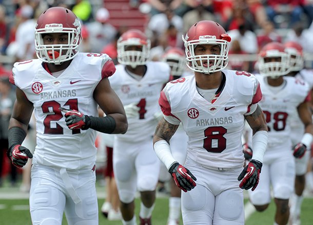 Arkansas players take the field before the Razorbacks' Red-White Scrimmage on Saturday at Razorback Stadium in Fayetteville. 
