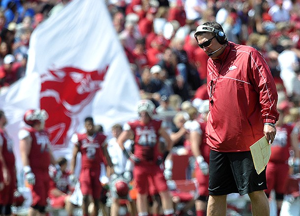  University of Arkansas coach Bret Bielema watches the Razorbacks warm up as they prepare for the start of Saturday's Red White Scrimmage at Razorback Stadium in Fayetteville.