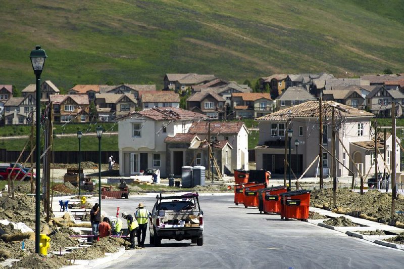 Construction crews work on new homes being built in San Ramon, California, U.S., on Friday, April 12, 2013. New-home construction in the U.S. jumped more than forecast in March as multifamily projects climbed to the highest level in more than seven years. Photographer: David Paul Morris/Bloomberg