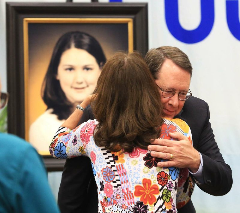 Charles Fuller hugs Sharon Harris, a nurse who cared for his daughter Rachel, 14 (shown in photograph), after she was brought in with burns she suffered in the crash of American Airlines Flight 1420 at Little Rock National Airport in 1999. Rachel later died from her injuries. Charles and Cindy Fuller made a donation Tuesday to Arkansas Children's Hospital to honor their daughter and those who treated her at the ACH Burn Center in Little Rock. 