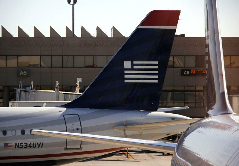 In this Monday, Feb. 25, 2013, photo US Airways jets are seen at Phoenix Sky Harbor International Airport, in Phoenix. U.S. Airways Group Inc. reports quarterly financial results before the market opens on Tuesday, April 23, 2013. (AP Photo/Gene J. Puskar)