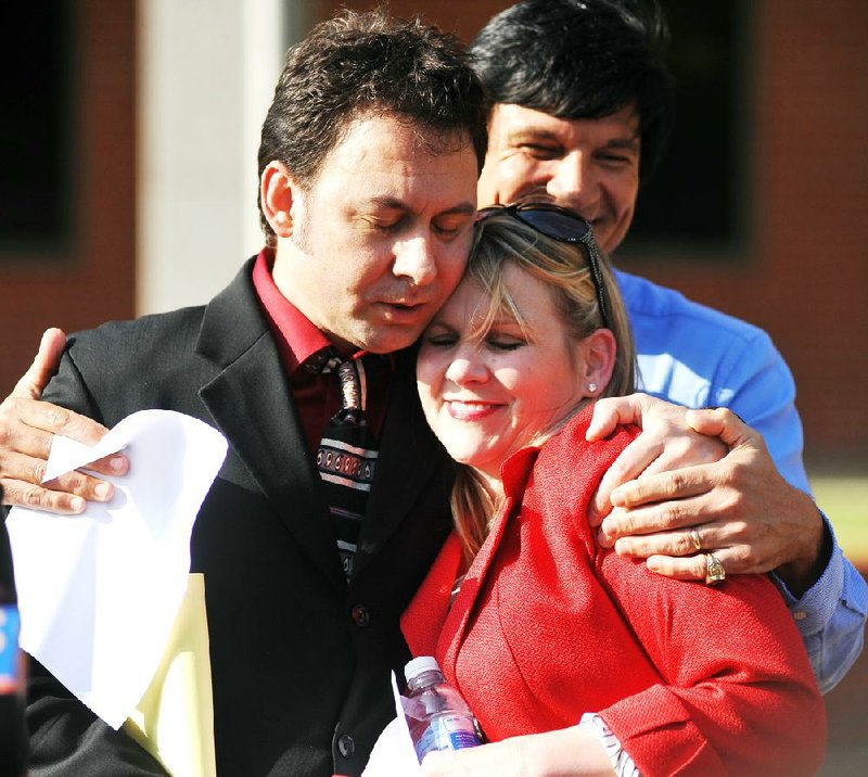 Paul Kevin Curtis, who had been in custody under suspicion of sending ricin-laced letters to President Barack Obama and others, left, hugs his attorney Christi McCoy during a news conference following his release Tuesday, April 23, 2013 in in Oxford, Miss. The charges were dismissed without prejudice, which means they could be re-instated if prosecutors so choose. (AP Photo/Oxford Eagle, Bruce Newman) MANDATORY CREDIT, MAGS OUT, NO SALES