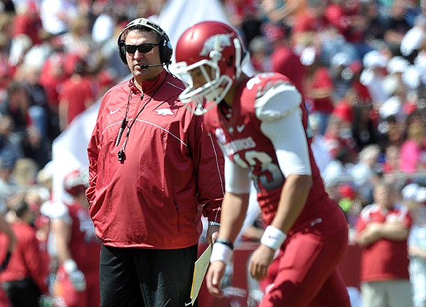 Arkansas coach Bret Bielema watches the Razorbacks warm up as they prepare for the start of the Red-White Scrimmage at Razorback Stadium in Fayetteville.