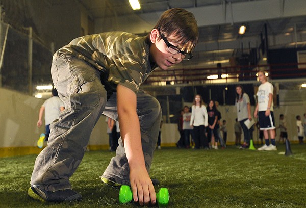 Blaine Pierce, 10, fourth-grader from Harp Elemenary School runs in a relay Tuesday at the Arkansas Governor’s Council on Fitness Great Arkansas Workout at the All-Star Sports Arena in Springdale. Fourth-graders from Harp and Asbell elementary schools had the opportunity to play different sports and drills as they learned about fitness and health. 