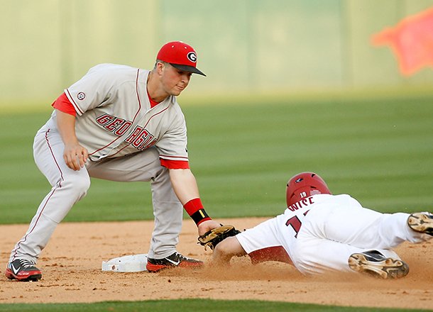 Arkansas' Jake Wise is tagged out by Georgia shortstop Kyle Farmer at second at Baum Stadium in Fayetteville on Friday, April 6, 2012.