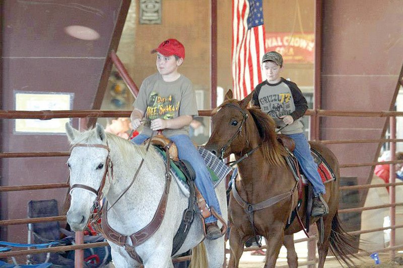 Bo Russell, left, and Scott Tucker ride their horses in the October 2012 Heber Springs Horse Show. Saturday kicked off the 2013 season of Heber Springs Horse Shows, sponsored by the Mountain Top Cowboy Church. 
