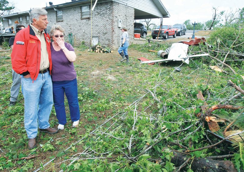 Gov. Mike Beebe comforts homeowner Lou Baker following a killer tornado that struck the Vilonia area on April 25, 2011. The twister claimed five lives, destroyed several homes and marred much of the landscape in its path. Now, two years later, both physical and emotional signs of the storm still remain.