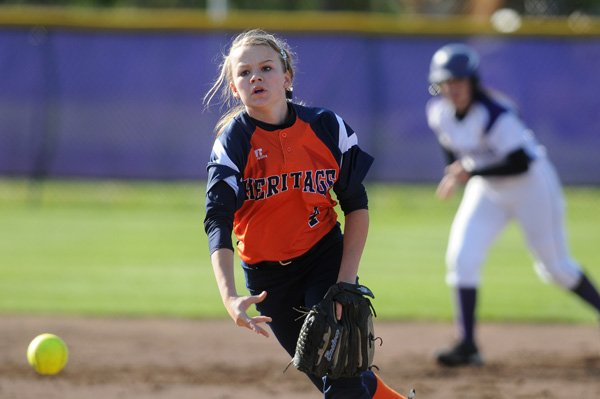 Lindsay Glynn of Rogers Heritage pitches during the game against Fayetteville on April 19 at the Lady Dawg Yard in Fayetteville. 