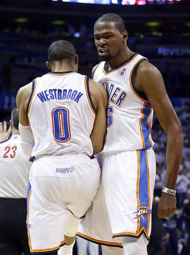 Kevin Durant (right) and teammate Russell Westbrook each scored 29 points to lead the Oklahoma City Thunder to a 105-102 victory over the Houston Rockets on Wednesday night. 