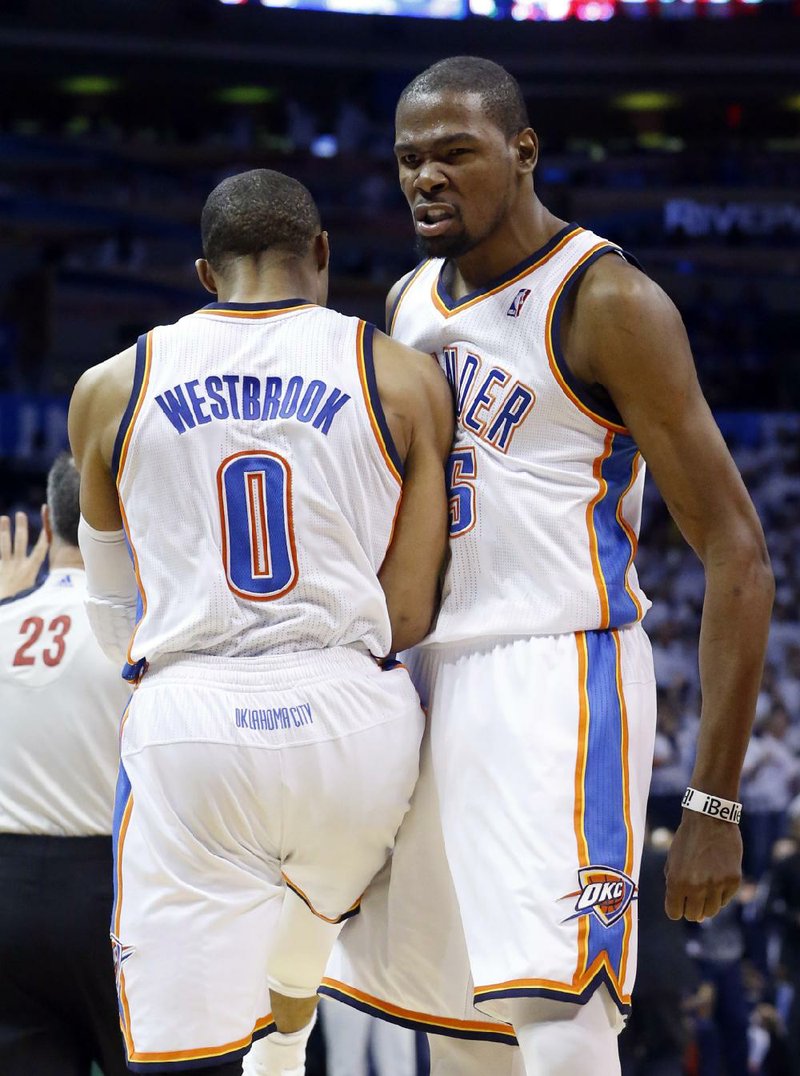 Kevin Durant (right) and teammate Russell Westbrook each scored 29 points to lead the Oklahoma City Thunder to a 105-102 victory over the Houston Rockets on Wednesday night. 