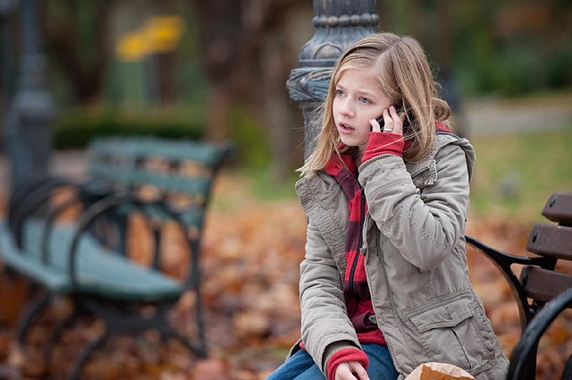 Young Isabel (Jackie Evancho) takes a call from her on-the-lam dad — a former radical — in Robert Redford’s political thriller The Company You Keep. 