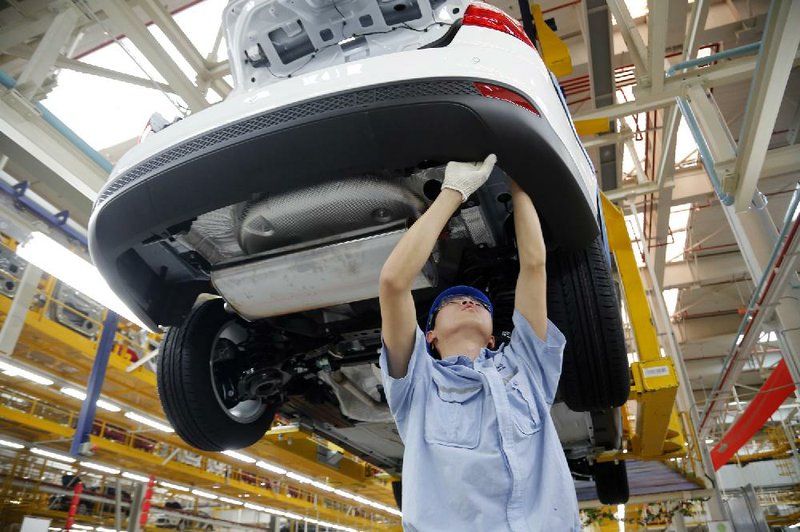 A worker assembles a vehicle at the Ford Motor Co. factory in Chongqing, China, on April 16. Ford reported a first-quarter profit of $1.6 billion on Wednesday. 