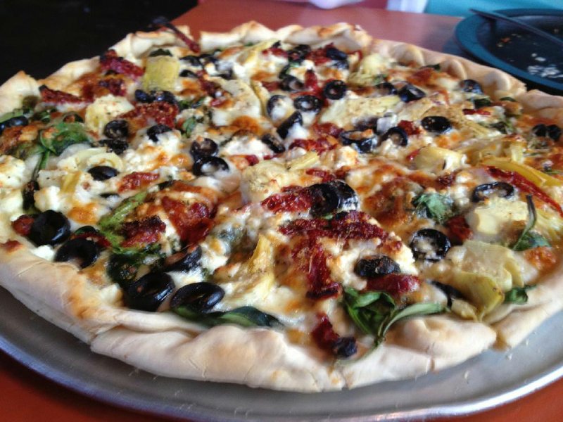 Pizza Cafe’s Mediterranean Pizza features mozzarella, feta, sun dried tomatoes, artichoke hearts, spinach and black olives on an olive-oil base. 