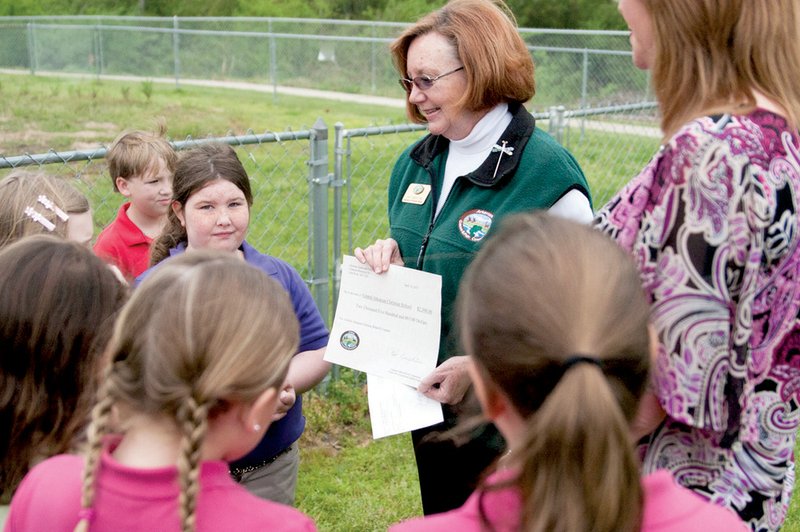 Pat Knighten, Project WILD coordinator for the Arkansas Game and Fish Commission, talks to Amanda Colclasure’s second-grade class at Central Arkansas Christian’s North Little Rock Elementary School about the butterfly garden that will be funded by a $2,500 grant the school recently received.