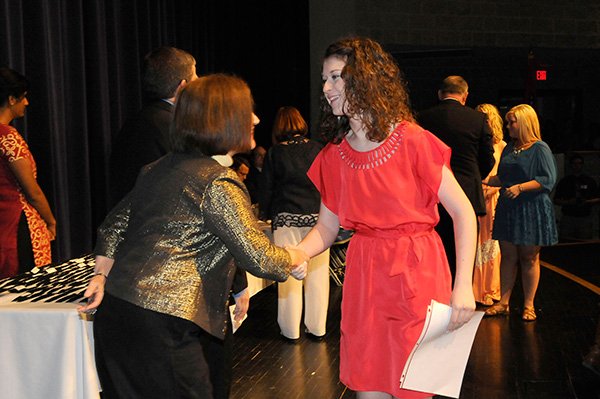 HIGH ACHIEVER
Amanda Simpson, a Rogers High School senior, is greeted by Rogers school superintendent Janie Darr, left, after Simpson received her academic award on Thursday April 25 2013 at the high school. More than 300 students received awards at the ceremony.