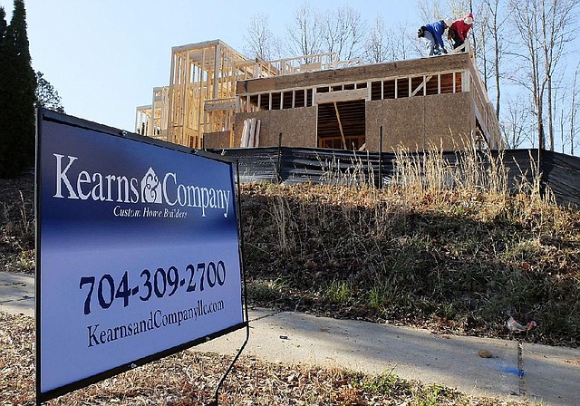 In this Friday, March 29, 2013, photo, a worker helps frame a new home under construction in Matthews, N.C. The Commerce Department reports on new-home sales for March on Tuesday, April 23, 2013. (AP Photo/Chuck Burton
