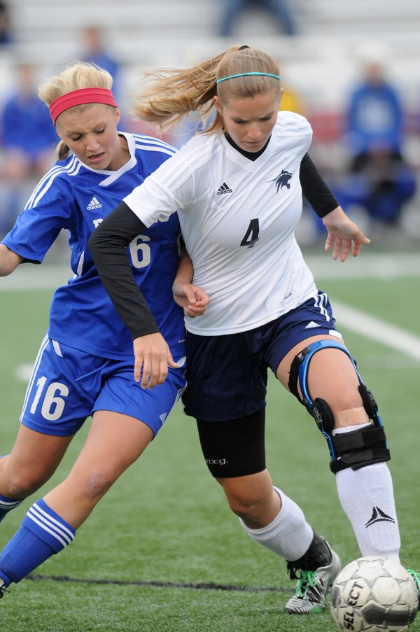 Sara Lachance, right, of Springdale Har-Ber fights for possession of the ball with Meagan Johnson of Rogers High on Friday at Jarrell Williams Bulldog Stadium in Springdale. 