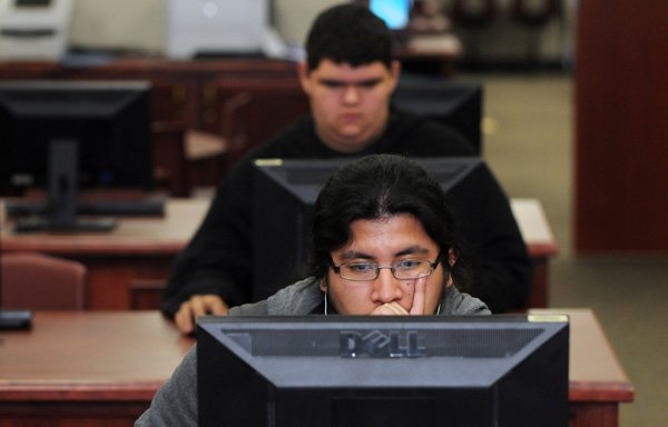 Aroldo Gabriel, 19, front, and Dalton Pistubbee, 16, both students in the Information Technology Academy, work on applications for Android devices Wednesday at Springdale High School. The IT Academy is one of five course-centralized programs for students at the high school. Students who want to focus in a specific area such as business, computer science, medicine, law, engineering or International Baccalaureate can participate in one of the academies in order to get a jump start in their knowledge of those areas. 