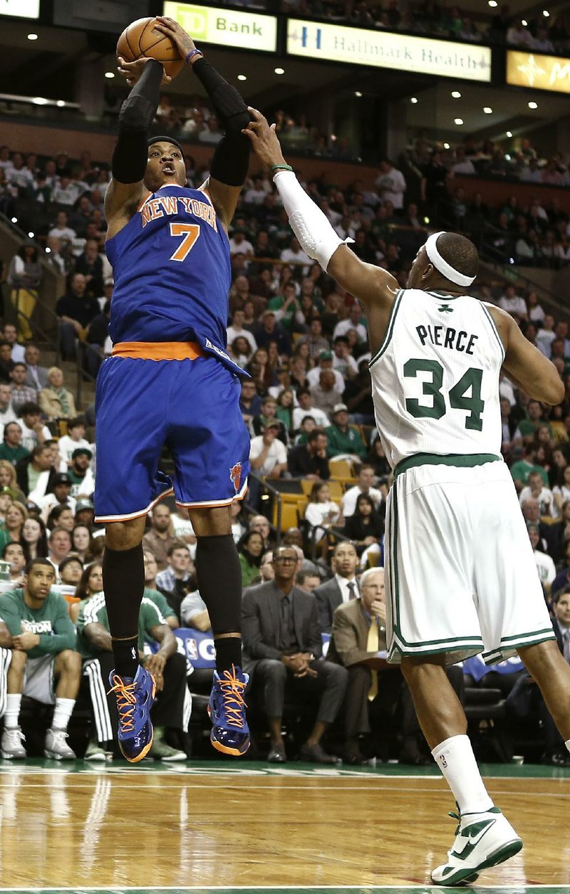 New York’s Carmelo Anthony (left) shoots over Boston’s Paul Pierce in the Knicks 90-76 victory that left the Knicks a victory from advancing in the NBA Eastern Conference playoffs. 