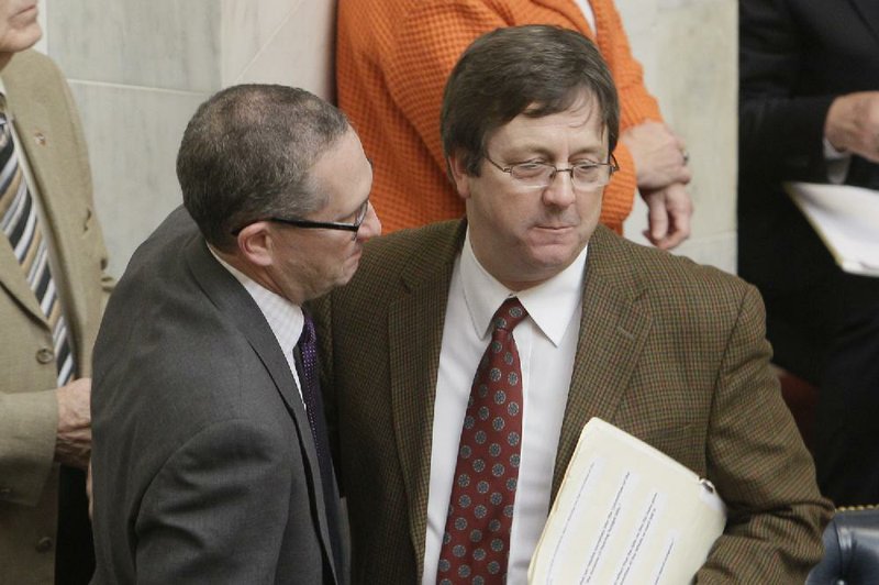 Sen. Paul Bookout, D-Jonesboro, left, speaks with Sen. Larry Teague, D-Nashville, in the Senate at the Arkansas state Capitol in Little Rock, Ark., after Teague presented budget legislation Monday, April 22, 2013. The budget won approval days after lawmakers passed a plan to use federal Medicaid dollars to purchase private insurance for thousands of low-income residents. (AP Photo/Danny Johnston)