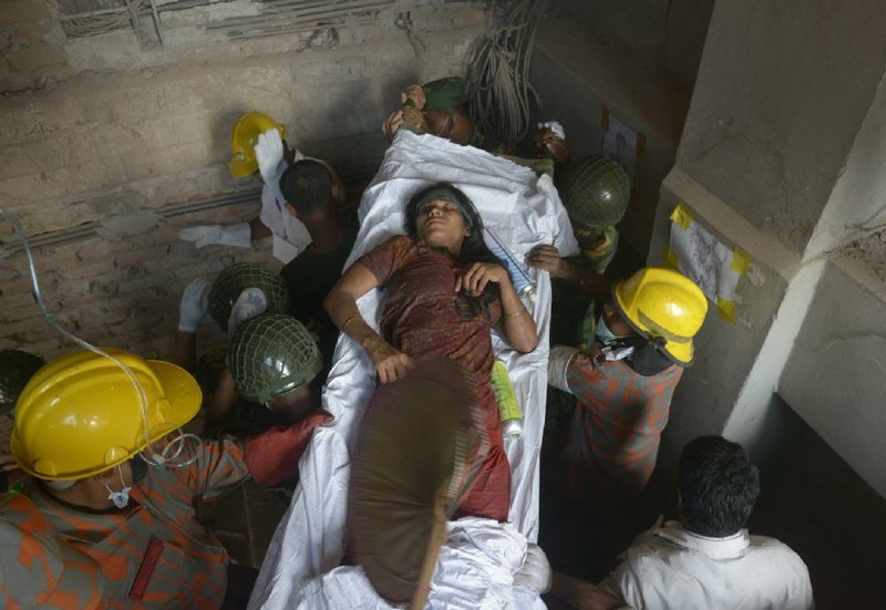 Rescue workers evacuate a survivor found in the garment factory building that collapsed Wednesday in Savar, near Dhaka, Bangladesh, Saturday, April 27, 2013. Police in Bangladesh took five people into custody in connection with the collapse of a shoddily-constructed building this week, as rescue workers pulled 19 survivors out of the rubble on Saturday and vowed to continue as long as necessary to find others despite fading hopes. (AP Photo/Ismail Ferdous)