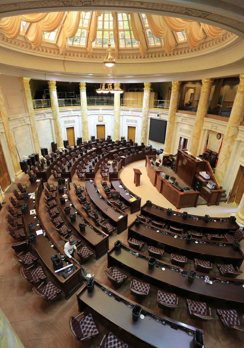 Leon Major vacuums the floor of the House Chambers at the state Capitol in Little Rock Tuesday. The 89th General Assembly of the Arkansas Legislature ended Tuesday.