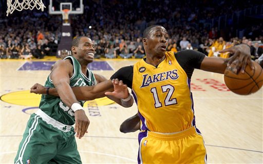 Boston Celtics center Jason Collins (left) battles Los Angeles Lakers center Dwight Howard (12) for a rebound during the first half of their NBA basketball game, Wednesday, Feb. 20, 2013 in Los Angeles. NBA veteran center Collins has become the first male professional athlete in the major four American sports leagues to come out as gay. Collins wrote a first-person account posted Monday, April 29, 2013 on Sports Illustrated's website.